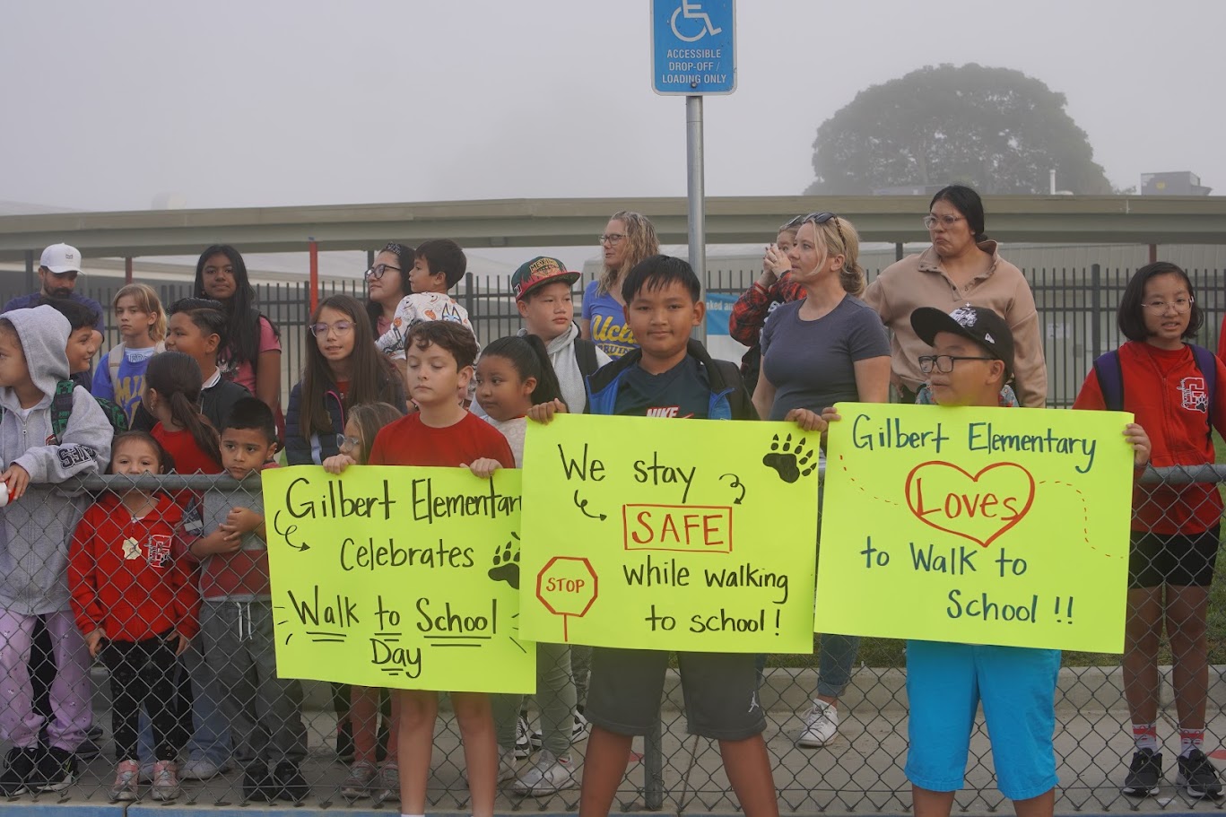 Gilbert students promote Walk to School day in front of the school.